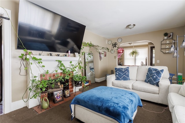 living room featuring arched walkways and carpet floors