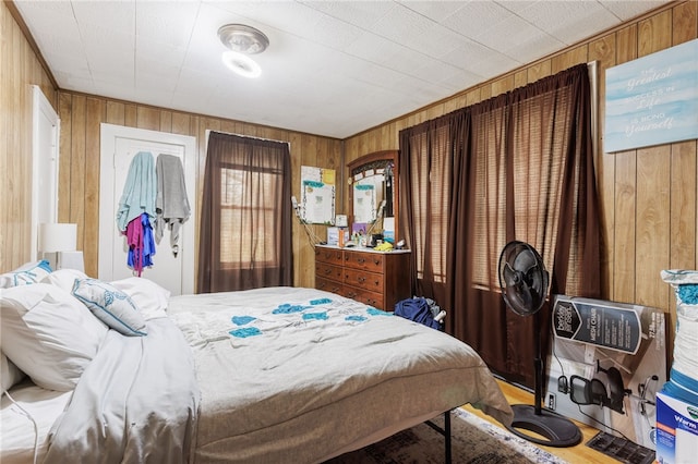 bedroom featuring wood walls