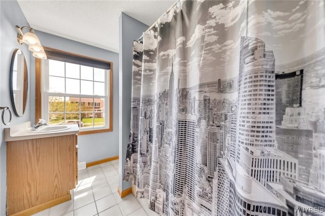bathroom with tile patterned floors, vanity, a shower with shower curtain, and baseboards
