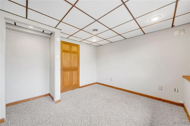interior space with a drop ceiling, recessed lighting, carpet flooring, and baseboards
