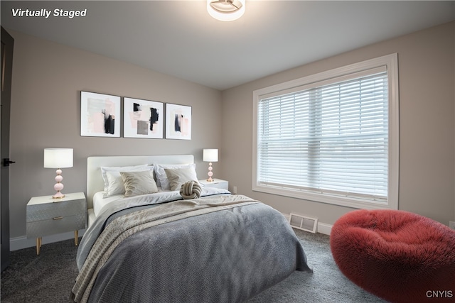 carpeted bedroom featuring visible vents and baseboards