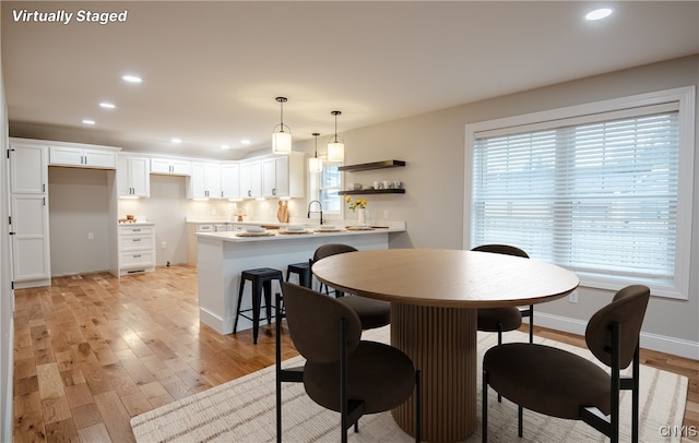 dining area with baseboards, recessed lighting, light wood-style flooring, and plenty of natural light