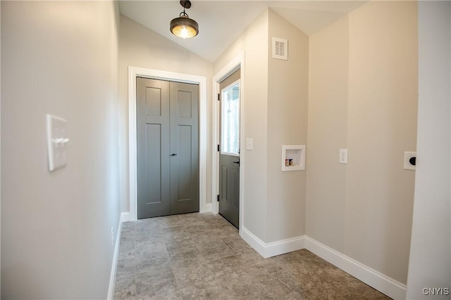 interior space featuring visible vents, vaulted ceiling, and baseboards