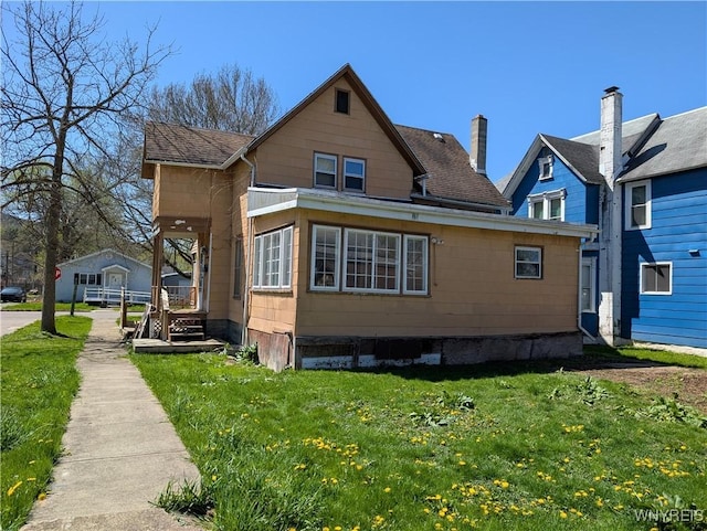 view of home's exterior with covered porch and a yard