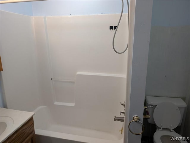 bathroom featuring toilet, shower / bath combination, and vanity