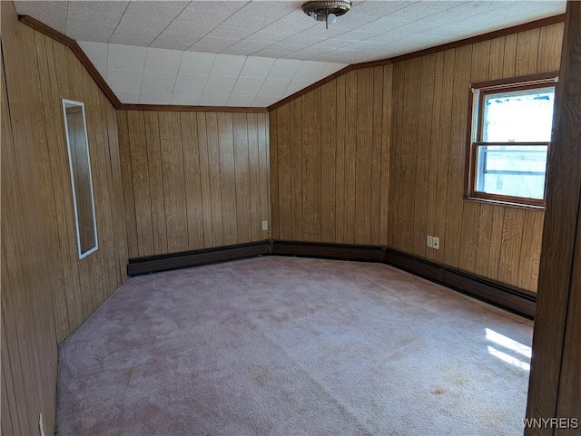 unfurnished room featuring wood walls, carpet flooring, and vaulted ceiling