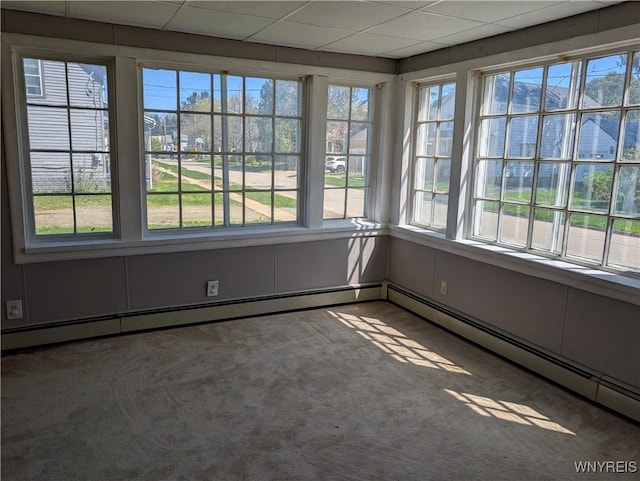 interior space featuring a baseboard heating unit and carpet floors