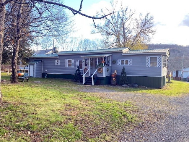 rear view of house featuring a yard
