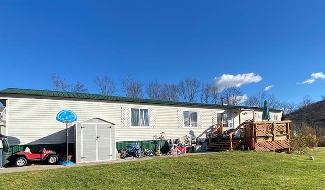 846-848 Silas Tompkins Rd, Hancock, NY 12760 - rear view of property with a lawn, a wooden deck, a storage unit, and a metal roof