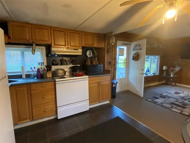 kitchen featuring electric stove, dark tile patterned floors, under cabinet range hood, brown cabinets, and black microwave