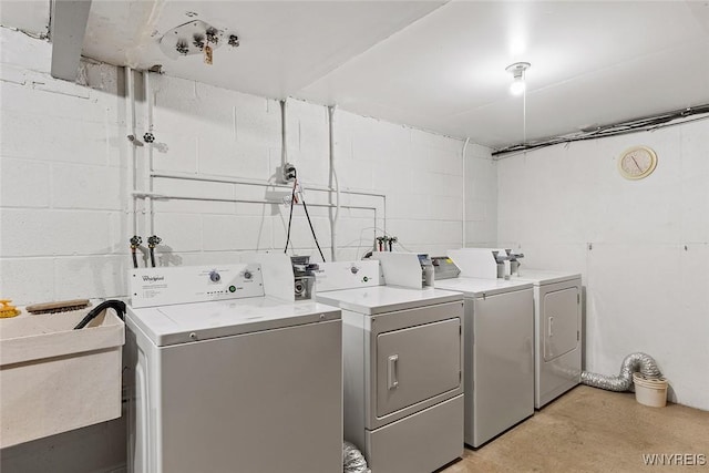 65 Guilford Ln Unit 5, Amherst, NY 14221 - washroom with concrete block wall, washing machine and clothes dryer, and a sink