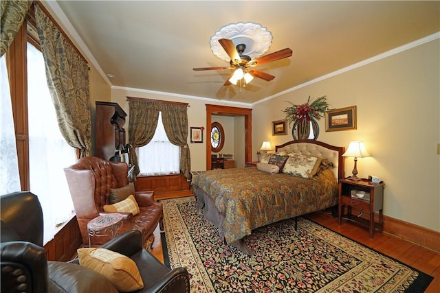 bedroom with ornamental molding, a ceiling fan, wood finished floors, and baseboards