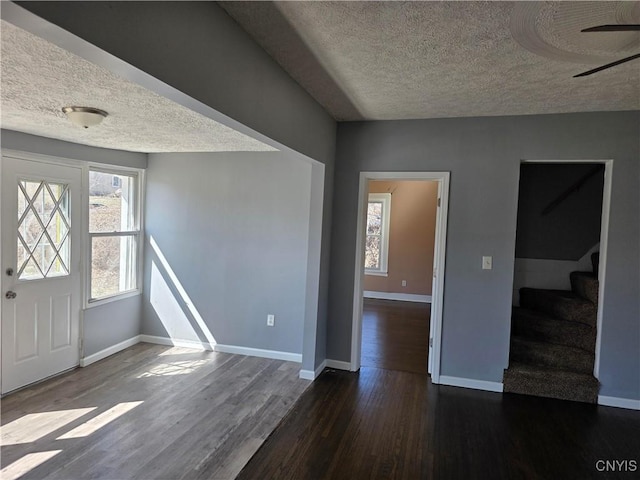 4844 Onondaga Rd, Onondaga, NY 13215 - entrance foyer featuring stairs, wood finished floors, a healthy amount of sunlight, and a textured ceiling