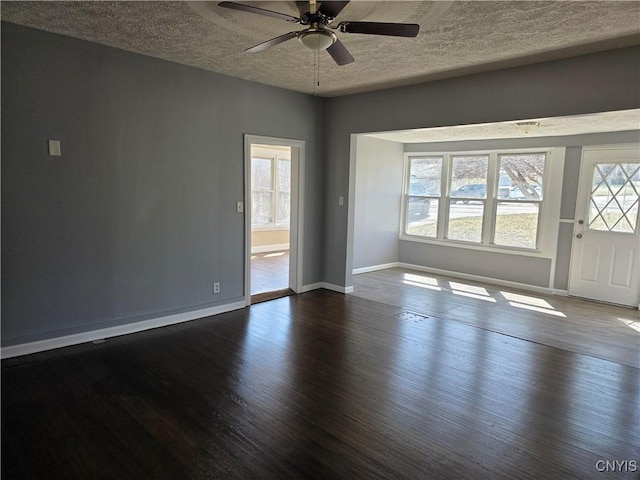 4844 Onondaga Rd, Onondaga, NY 13215 - spare room with a textured ceiling, ceiling fan, dark wood finished floors, and baseboards