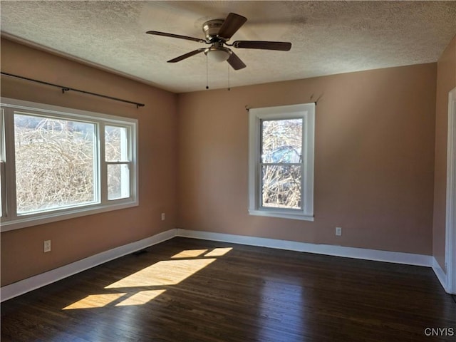 4844 Onondaga Rd, Onondaga, NY 13215 - unfurnished room featuring a textured ceiling, baseboards, wood finished floors, and plenty of natural light