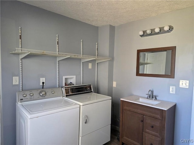 4844 Onondaga Rd, Onondaga, NY 13215 - washroom featuring washer and dryer, a sink, laundry area, and a textured ceiling