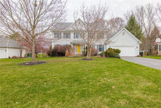 view of front of property with an attached garage, driveway, and a front lawn