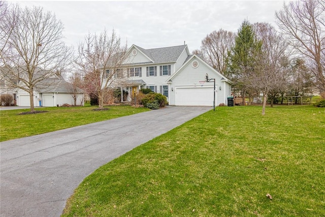 view of front of house with a garage, driveway, and a front lawn