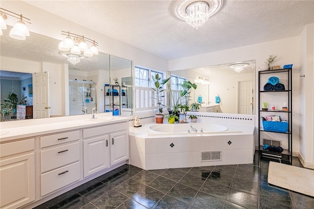 bathroom with visible vents, a shower stall, a bath, and a notable chandelier