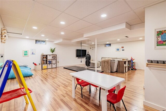 rec room with baseboards, a drop ceiling, recessed lighting, and light wood-style flooring