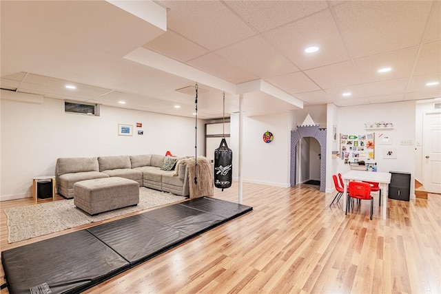 living area with a paneled ceiling, recessed lighting, baseboards, and wood finished floors