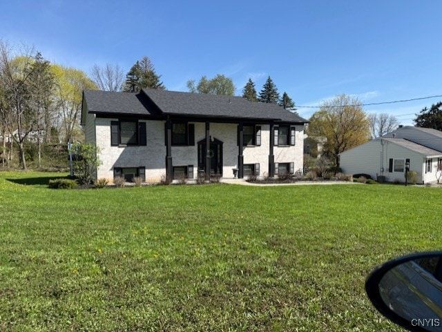 raised ranch featuring a front lawn