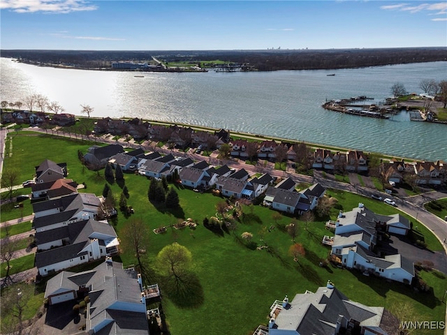 drone / aerial view with a residential view and a water view
