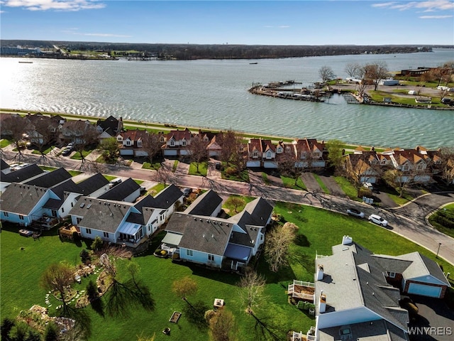 drone / aerial view with a residential view and a water view