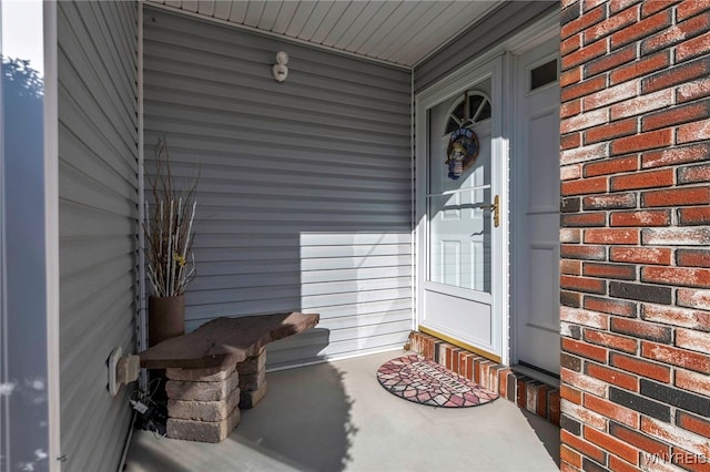 property entrance featuring brick siding