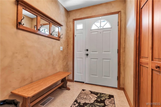 foyer with baseboards, visible vents, and light tile patterned flooring