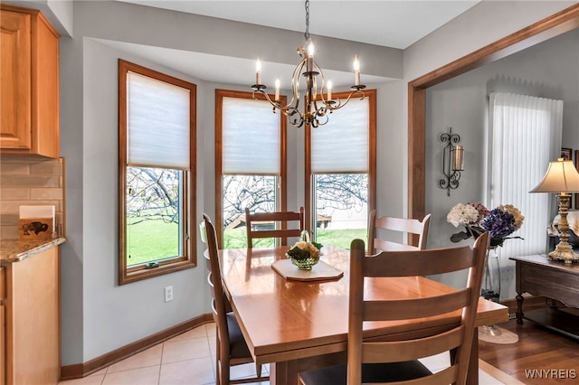 dining space with a notable chandelier and baseboards