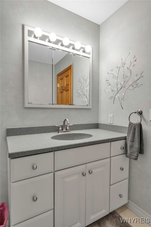 bathroom with tile patterned floors and vanity