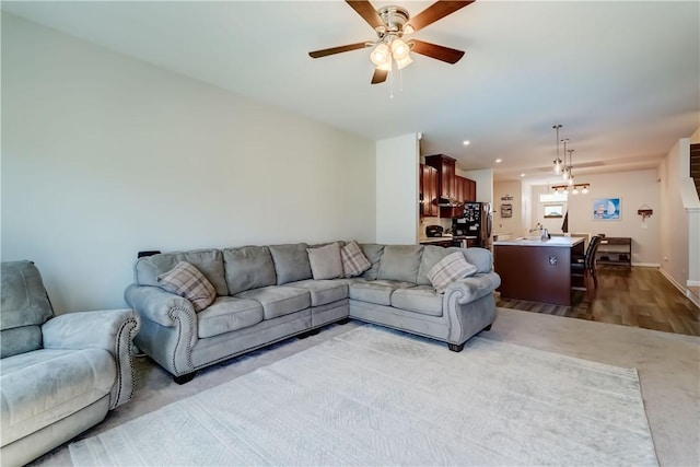 living area featuring a ceiling fan and wood finished floors