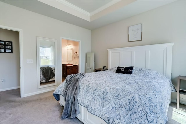 bedroom with baseboards, crown molding, connected bathroom, and light colored carpet