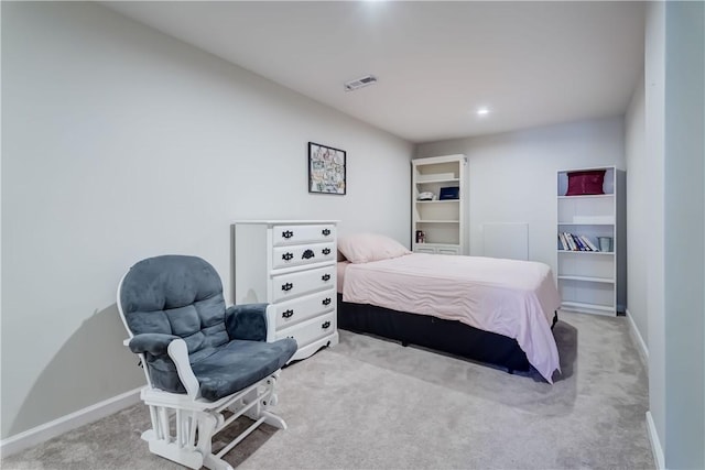 bedroom with visible vents, light carpet, and baseboards