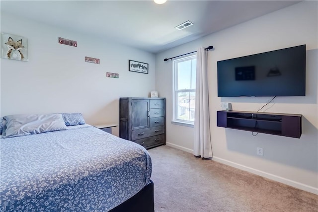 bedroom with visible vents, baseboards, and light carpet