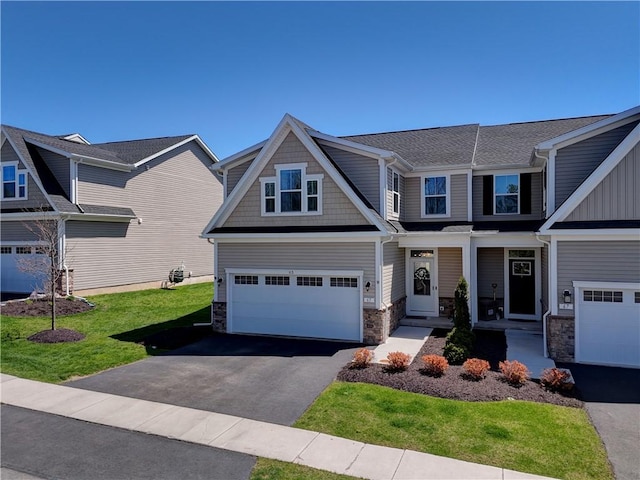 craftsman house with driveway, a front lawn, stone siding, and a garage