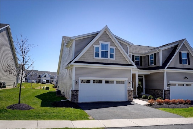 craftsman inspired home featuring a front yard, a garage, stone siding, central AC, and aphalt driveway