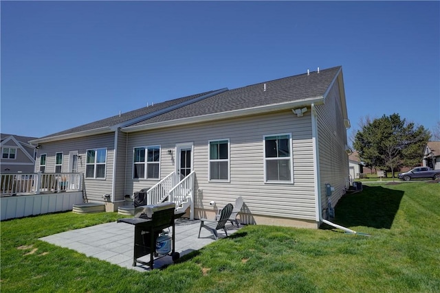 rear view of house featuring a patio and a lawn
