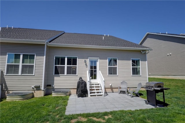 rear view of property with a patio, a yard, and entry steps
