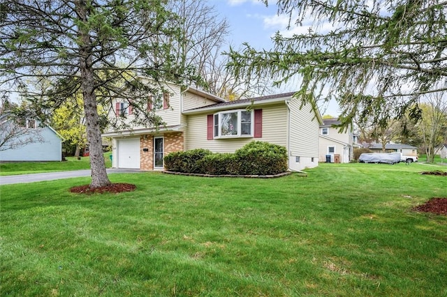 tri-level home featuring brick siding, driveway, and a front yard