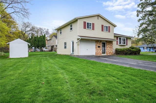view of front of home featuring driveway, brick siding, a front yard, and an attached garage