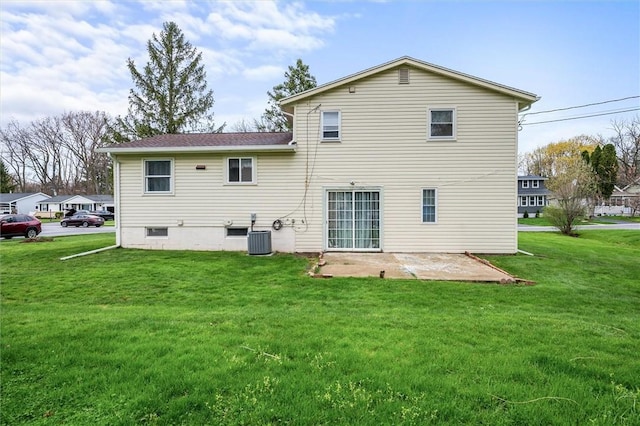 back of house featuring a lawn, central air condition unit, and a patio area