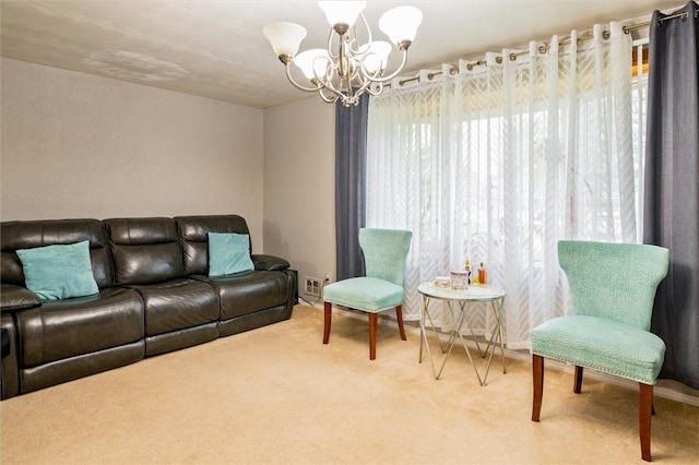 carpeted living room with an inviting chandelier