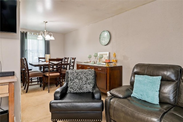 sitting room featuring a notable chandelier and carpet