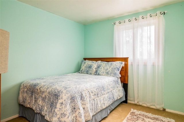 carpeted bedroom with baseboards