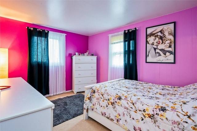 carpeted bedroom with multiple windows