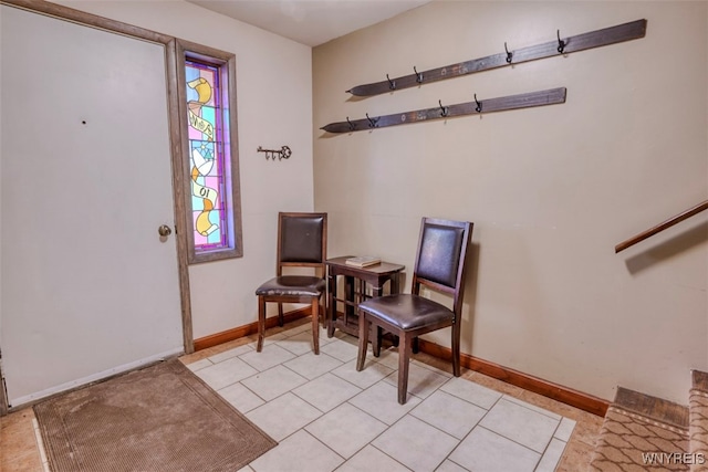 living area featuring light tile patterned floors and baseboards