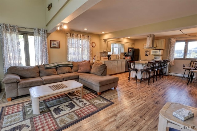 living room featuring recessed lighting and light wood-style flooring