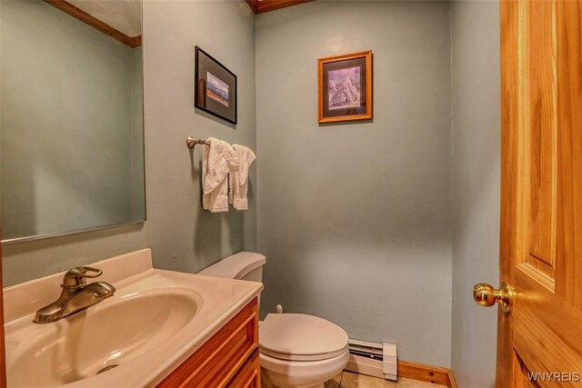 half bath featuring a baseboard heating unit, toilet, and vanity